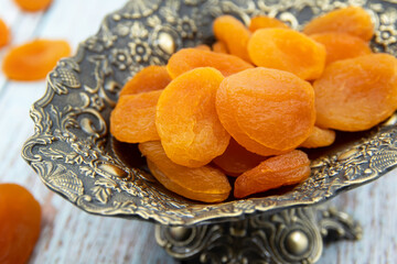 Delicious and healthy dried apricots in ceramic bowls. Healthy food concept. Top view. 