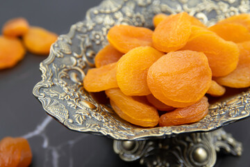 Delicious and healthy dried apricots in ceramic bowls. Healthy food concept. Top view. 