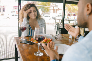 Couple discussing during a date at a restaurant.
