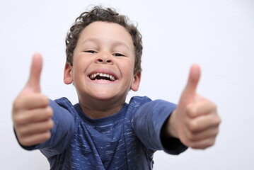boy with thumbs up gesture on white background stock photo