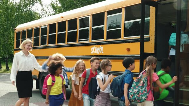 Children studying and having fun at school. Multiethnic group of kids going on a school trip with the bus