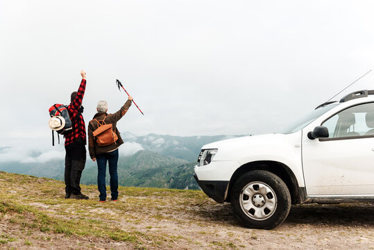 Anonymous travelers enjoying freedom in mountains