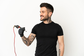 Tattoo artist man over isolated white background looking side