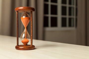 Hourglass with concept of passing time, race against time, urgency and priority. Hours, days,...