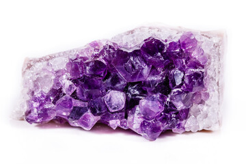 Macro mineral stone purple amethyst in crystals on a white background