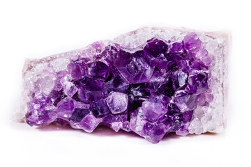 Fototapeta premium Macro mineral stone purple amethyst in crystals on a white background