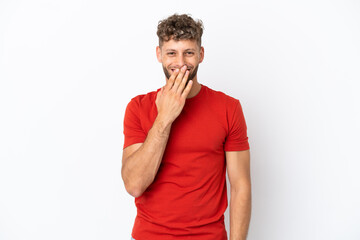 Young caucasian handsome man isolated on white background happy and smiling covering mouth with hand