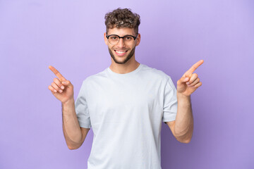 Delivery caucasian man isolated on purple background pointing finger to the laterals and happy