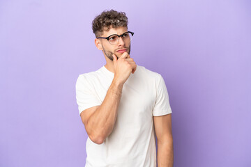Delivery caucasian man isolated on purple background and looking up