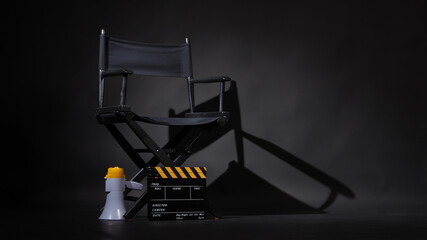 Black director chair and Clapper board or movie Clapperboard with megaphone on black background.use...