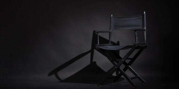 Black director chair is isolated on black background.it use in video production or movie industry.studio shot.