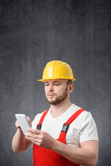 Portrait of a worker using his smartphone