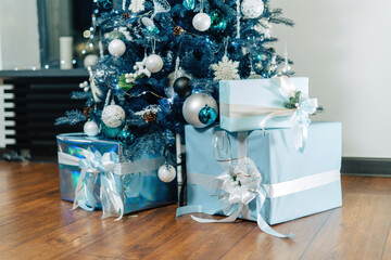 Gifts under christmas tree, all in shades of blue. Modern and stylish.