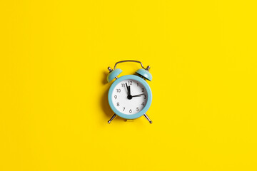 Blue vintage clock on yellow background in honor of Ukrainian Independence Day