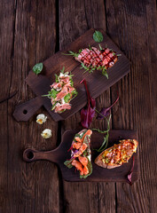 Variety of healthy sandwiches on a dark background in a rustic style. Top view