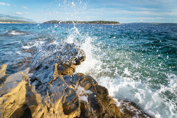 Waves splashing on the rocks of the shore adriatic sea