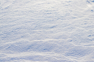 Winter background with snow-covered ground after a blizzard. Snow on the ground in sunny weather