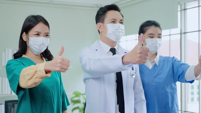 smart doctor team stood with their thumbs up confidently.
