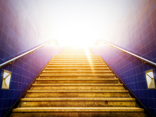 Extremely hot sunlight shining through a subway entrance during a hot summer day. The grey stairs...