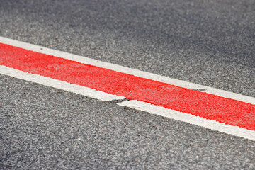 Fototapeta premium Asphalt road. Double lane road stripes white and red. Selective focus
