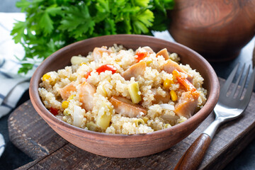 Chicken with vegetables and quinoa on dish on table