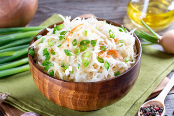 Sauerkraut salad in a wooden plate. Healthy food