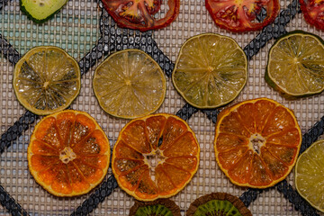 Dry color fruit and vegetable on color table and black drying net
