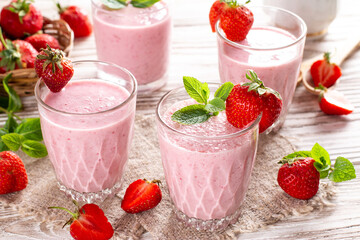 Food and drink, healthy dieting and nutrition, lifestyle, vegan, alkaline, vegetarian concept. Pink smoothie with banana and strawberry on wooden background.