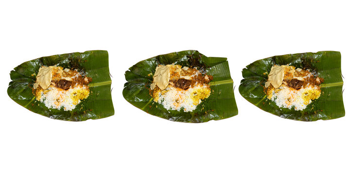 Kerala Style Rice And Curry Served In Banana Leaves