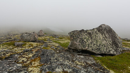 Granite hills, rocks, and fog.