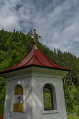 Wolfaukapelle chapel in sunny cloudy morning in Austria mountains