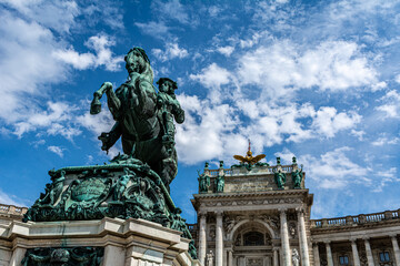 Fototapeta na wymiar Low angle view of the Statue of Prince Eugene on the Herosquare in Vienna, Austria in front of the Hofburg Palace