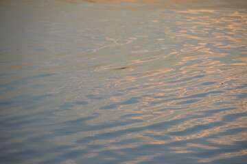 Sunset glare on the water on the pond