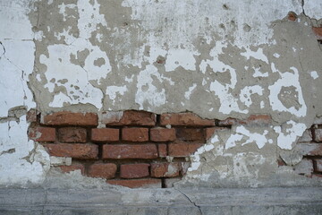 Beautiful texture. Background. Fragment of a wall with oval plaster. Devastation.