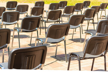 Chairs are placed in the park at a distance.