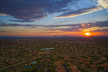 An aerial view of the sun setting over the Arizona desert in the summer.