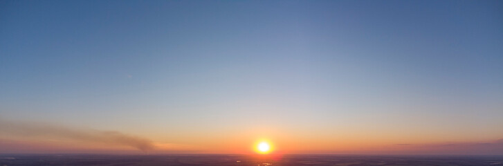Orange sunset. Panorama of the evening sky.