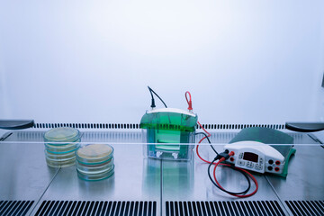 Scientific electrophoresis equipment and stacks of petri dishes are installed in a sterile...