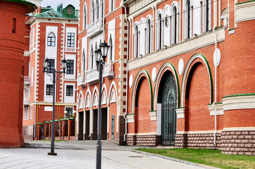 City street with houses of red and white brick. Russia Yoshkar Ola 01.05.2021. High quality photo