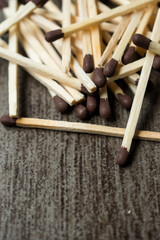 Some wooden matches on a clorful on a grey wooden surface 