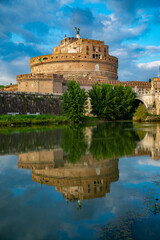 Castel Sant'Angelo, or Mausoleum of Hadrian, located near the Vatican, while it is reflected in the Tiber with the bridge of the Angels, on an autumn day. Vatican, Rome, Italy.
