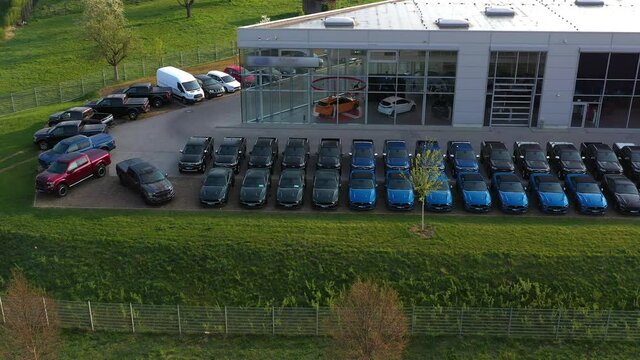 Aerial view of storage parking with new unsold cars. Cars dealership inventory distribution automobile and automotive business.