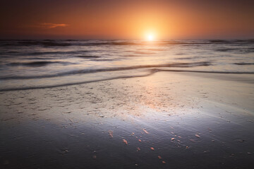 Beautiful sunrise over the sea. Motion blur waves. Fresh new start concept.