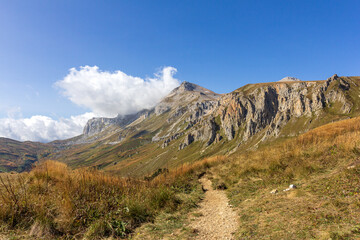 Panoramic views of the mountains from hiking trails in the mountainous area on a warm, sunny autumn day, walking and communicating with nature.