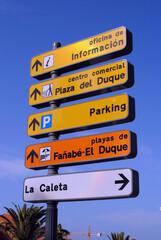 Fototapeta premium Close Up of Colourful Signpost against Blue Sky
