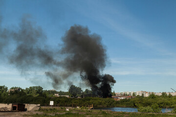 A sawmill fire with a huge column of black smoke