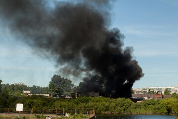 A sawmill fire with a huge column of black smoke
