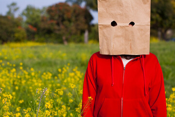 Bag head standing in a field