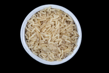 Top view of integral rice on glass bowl isolated on black background in Brazil