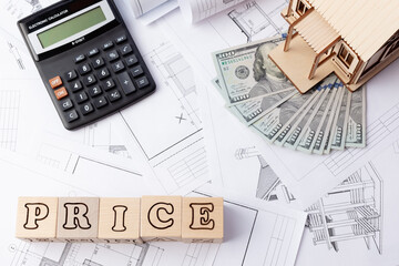drawings with dollars and layout of the house, calculator and cubes with the inscription price